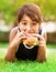 Teen boy eating burger outdoors