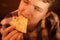 Teen boy eats pizza and enjoys it, closeup enjoying and savoring.