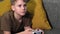 Teen boy focused playing video games with a portable game console