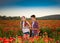 Teen boy and girl posing on the poppy field