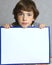 Teen boy hold blank paper sheet in frame