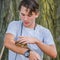 Teen Boy Holds Small Rodent at Petting Zoo