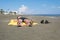 Teen boy lies on yellow towel and sunbathes on the beach. Traveling on an airplane with children. Concep