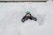 Teen boy sitting in homemade snow fort