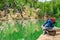 Teen boy sitting on the shore of Piskovna lake