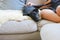 Teen boy snuggling on couch with pet dog. Man\'s best friend. Black kelpie x labrador breed