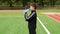 Teen boy soccer player drinks water from a plastic bottle