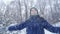 Teen boy throws snow in the winter forest. Active lifestyle, winter activity, outdoor winter games concept