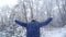 Teen boy throws snow in the winter forest. Active lifestyle, winter activity, outdoor winter games concept