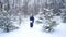 Teen boy throws snow in the winter forest. Active lifestyle, winter activity, outdoor winter games concept