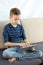 Teen boy using tablet. Child boy playing game or checking social media on tablet during recreation time at home.