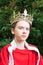 Teen boy wearing crown acting king