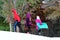 Teen Boy and Young Girls Carry Sleds On a Snowy Hill