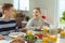 Teen brother and sister eating healthy breakfast at home