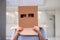 Teen with carton head mask