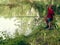 Teen child catches a fishing rod on the pond