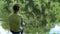 Teen child catches a fishing rod on the pond.