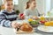 Teen children having healthy breakfast at home before school