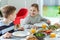 Teen children talking during healthy breakfast in the morning before going to school