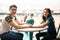 Teen Couple With Bowling Ball Holding Hands Over Table