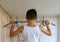 Teen doing exercises on the crossbar in the home sports corner