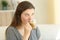 Teen drinking a coffee with milk looking away at home