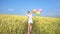 Teen female with balloons having fun in field