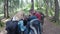 Teen friends travelers looking at the map planning to trekking through forest hiking and adventure in forest concept -