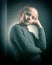 Teen girl 9-12 years old, looks into the frame, emotional studio portrait on a gray background