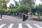 Teen girl ballet dancer standing on a toe in a ballet pose on a zebra crossing on a city street