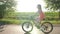 Teen girl biking through the fields in summer