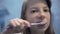 teen girl brushing her teeth, oral care