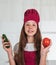 teen girl in cook uniform prepare food in kitchen, vegetables