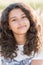 Teen girl with curly dark hair on nature