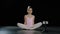 Teen girl dancer gymnast acrobat ballerina child making butterfly stretch exercise sitting on floor in dance studio hips