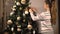 Teen girl decorate chrismas tree