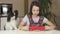 Teen girl and dog Papillon prepare cookies, rolling dough with rolling pin stock footage video