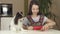 Teen girl and dog Papillon prepare cookies, rolling dough with rolling pin stock footage video