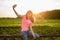 Teen girl doing selfie on phone on sunset background.