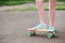 Teen girl down the street with a skateboard