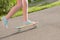 Teen girl down the street with a skateboard