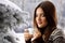 Teen girl drinking coffee over winter nature background