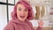 Teen girl fashion blogger with pink hair talking to camera recording vlog.