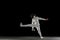 Teen girl in fencing costume with sword in hand isolated on black background