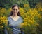 Teen Girl in Field of Goldenrod Flowers