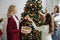 teen girl giving bauble to smiling