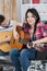 Teen girl handicapped guitarist sitting on wheelchair