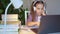 Teen girl in headphones listens to lesson, distance online learning home