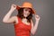 Teen girl hold orange straw hat