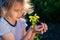 Teen girl holding in hands green young plant. little farmer. gardening